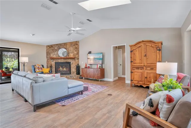 a living room with furniture a fireplace and a flat screen tv