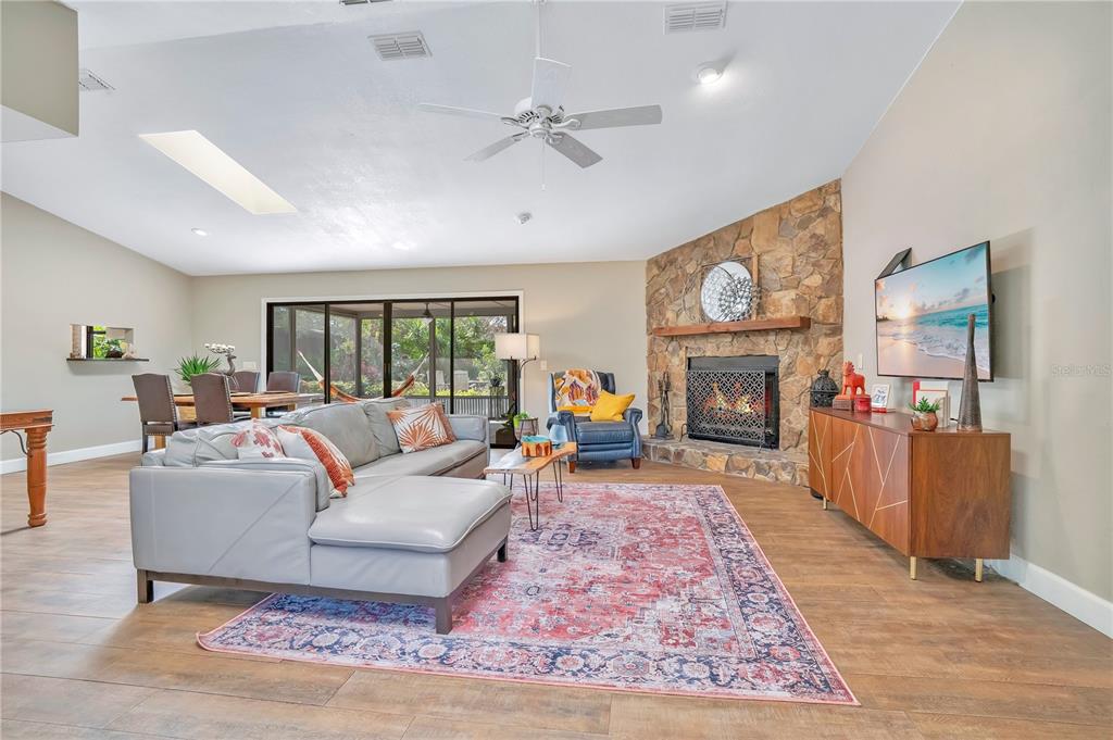 9488 Shortleaf Court Apopka, FL 32703 - Photo 13 of 60 a living room with furniture a fireplace and a flat screen tv