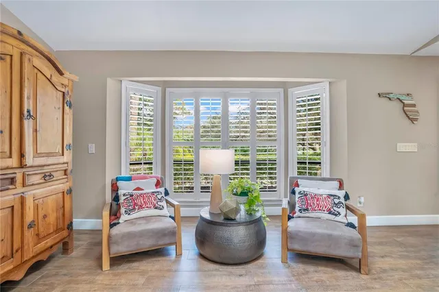 a view of a workspace with furniture and a window