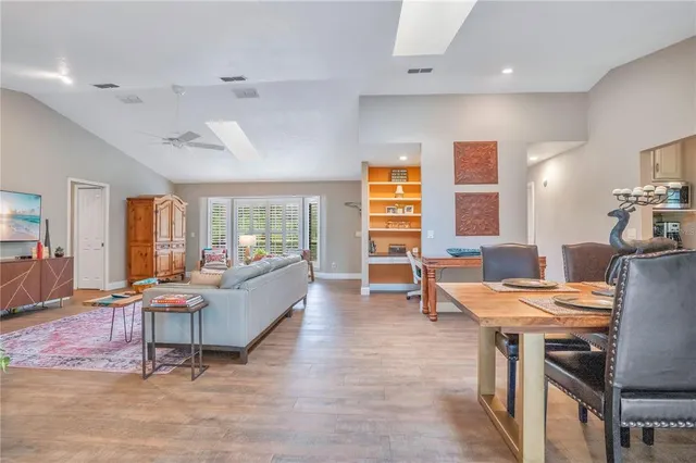 a view of a work space with wooden floor and furniture