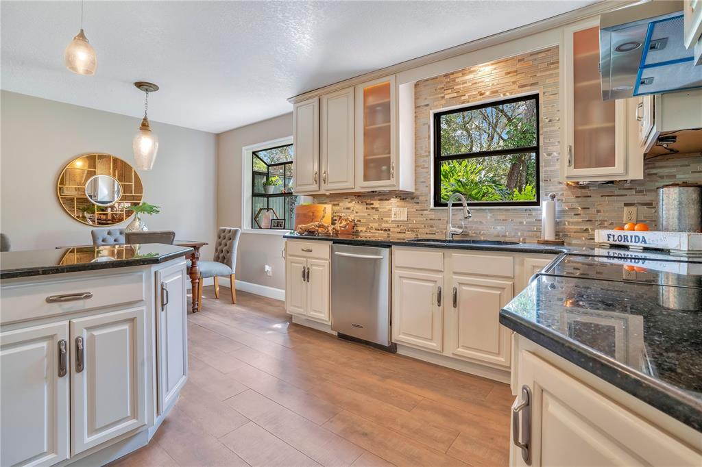 9488 Shortleaf Court Apopka, FL 32703 - Photo 29 of 60 a kitchen with stainless steel appliances granite countertop a stove a sink and a microwave