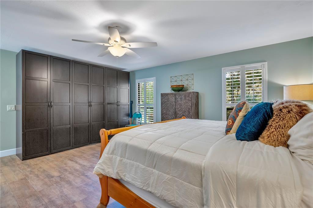 9488 Shortleaf Court Apopka, FL 32703 - Photo 32 of 60 a bedroom with a large bed and a chandelier