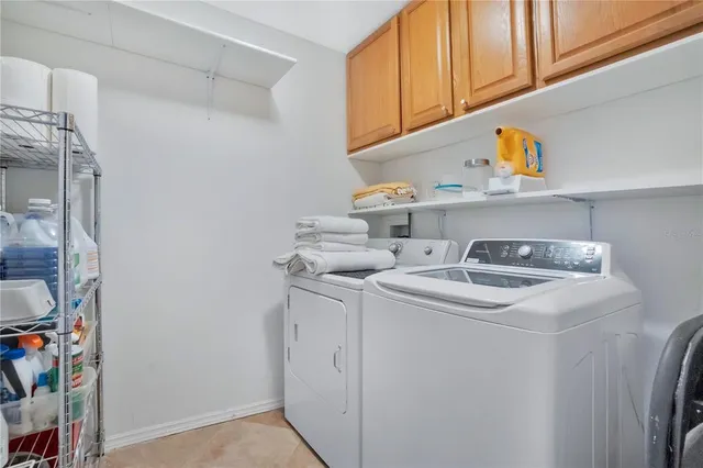 a living room with patio furniture and a floor to ceiling window