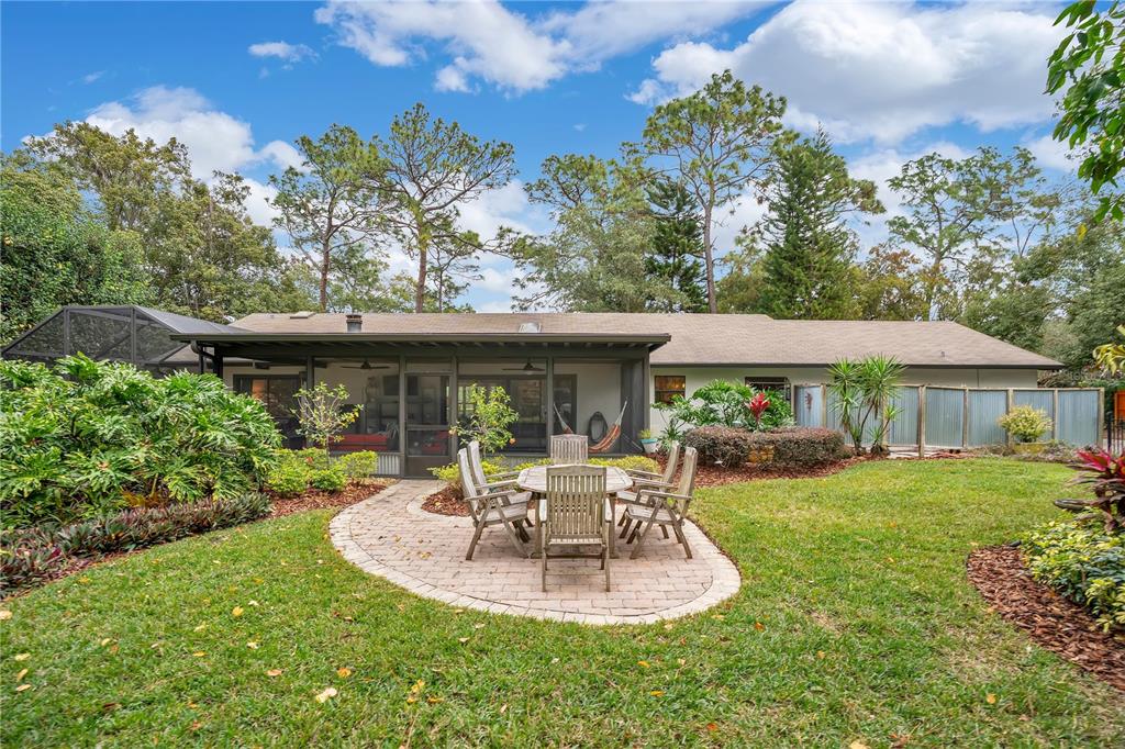 9488 Shortleaf Court Apopka, FL 32703 - Photo 54 of 60 a view of a house with a yard patio and furniture