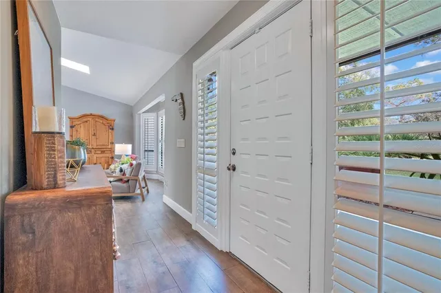 a view of hallway with wooden floor