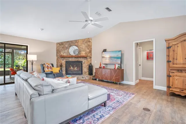 a living room with fireplace furniture and a window