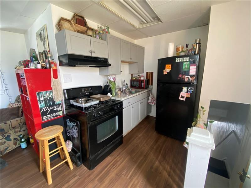 1136 Brownsville Road Pittsburgh, PA 15210 - Photo 11 of 28 a kitchen with stainless steel appliances granite countertop a stove and a refrigerator
