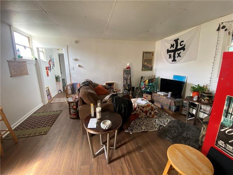 1136 Brownsville Road Pittsburgh, PA 15210 - Photo 12 of 28 a living room with furniture and a flat screen tv