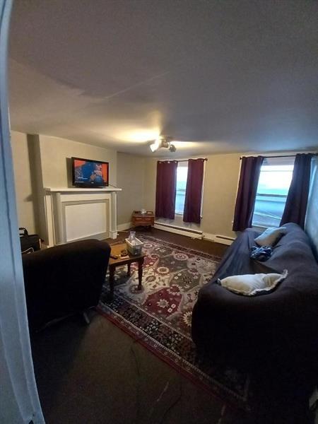 1136 Brownsville Road Pittsburgh, PA 15210 - Photo 15 of 28 a living room with furniture and a flat screen tv