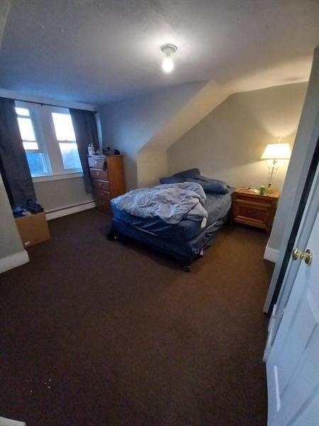 1136 Brownsville Road Pittsburgh, PA 15210 - Photo 17 of 28 a bedroom with a bed and a mirror