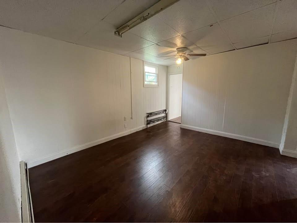 1136 Brownsville Road Pittsburgh, PA 15210 - Photo 19 of 28 an empty room with wooden floor and fan