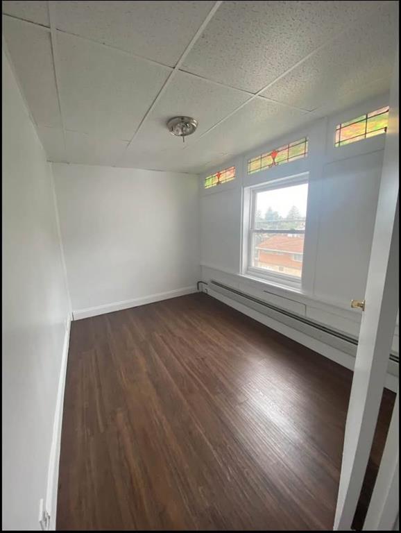 1136 Brownsville Road Pittsburgh, PA 15210 - Photo 21 of 28 an empty room with wooden floor and windows