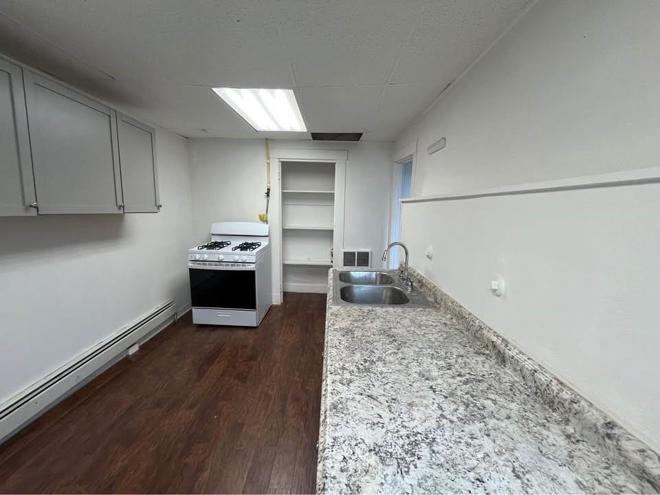 1136 Brownsville Road Pittsburgh, PA 15210 - Photo 24 of 28 a kitchen with a stove and a refrigerator
