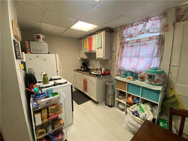 1136 Brownsville Road Pittsburgh, PA 15210 - Photo 8 of 28 a room with furniture a rug and a window