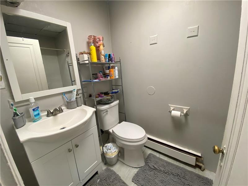 1136 Brownsville Road Pittsburgh, PA 15210 - Photo 10 of 28 a bathroom with a sink toilet and vanity