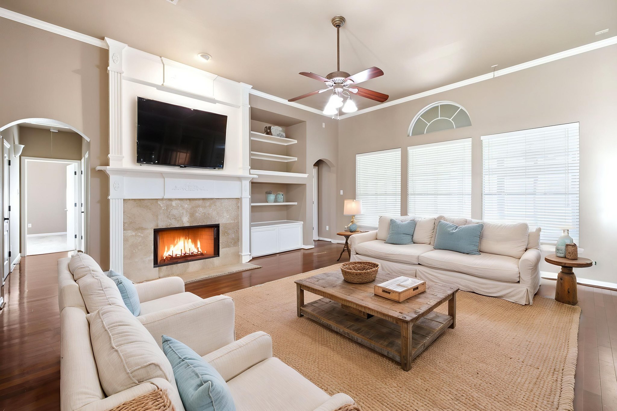 271 Rollin N Ranch Road Blanco, TX 78606 - Photo 14 of 40 A welcoming living area boasts a cozy fireplace, ample seating, and a wealth of natural light.
