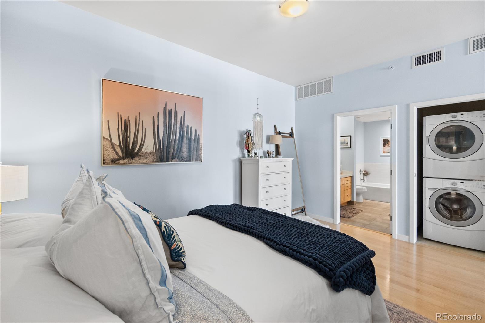 1438 Little Raven Street, Unit 310 Denver, CO 80202 - Photo 13 of 24 a bedroom with a bed and a cabinets