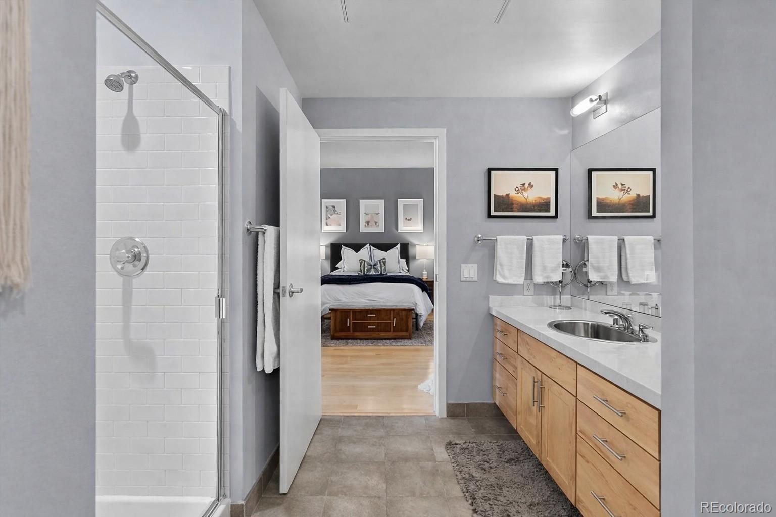 1438 Little Raven Street, Unit 310 Denver, CO 80202 - Photo 14 of 24 a kitchen with stainless steel appliances granite countertop a refrigerator and a stove