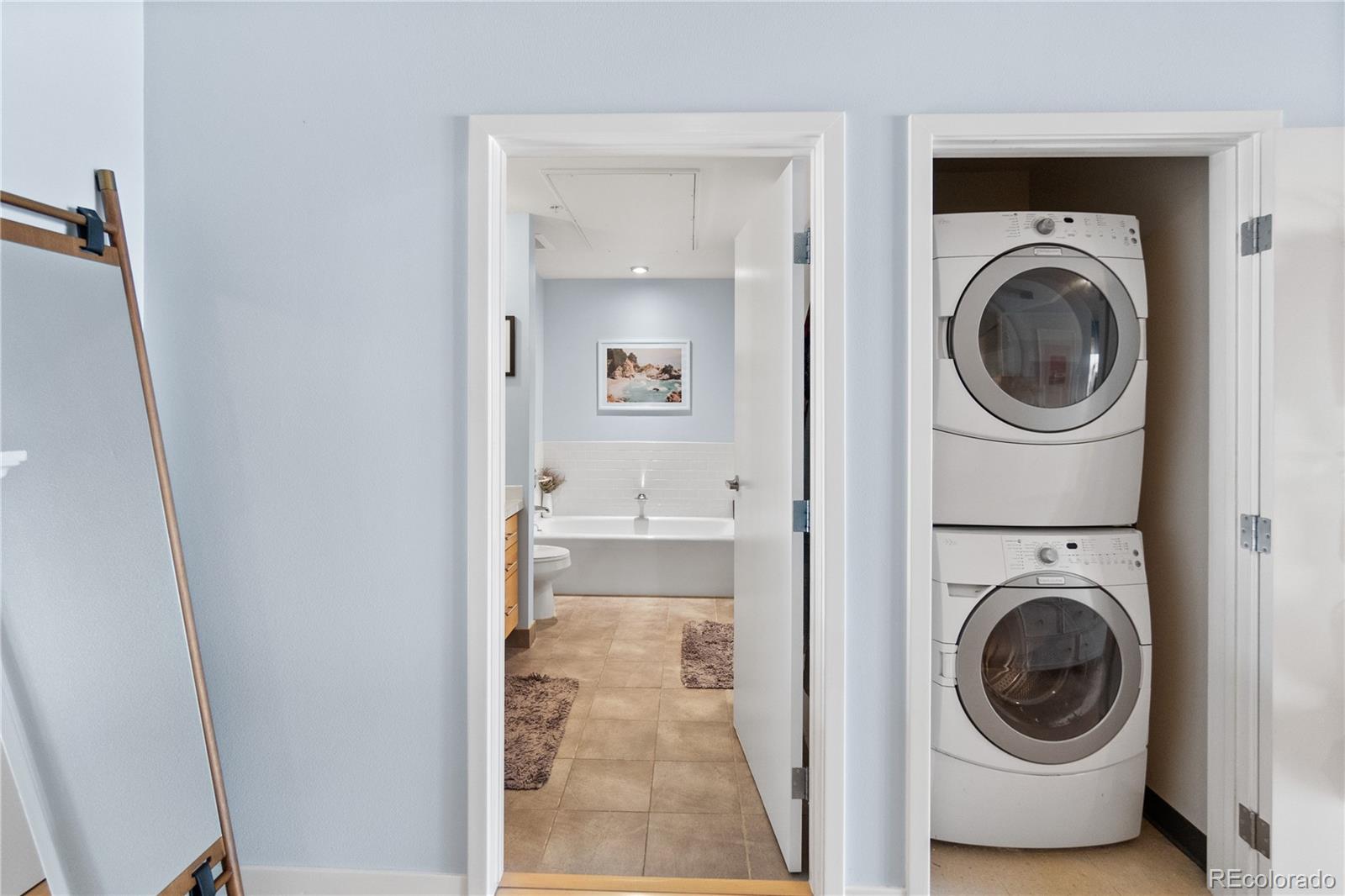 1438 Little Raven Street, Unit 310 Denver, CO 80202 - Photo 15 of 24 a view of a hallway with washer and dryer