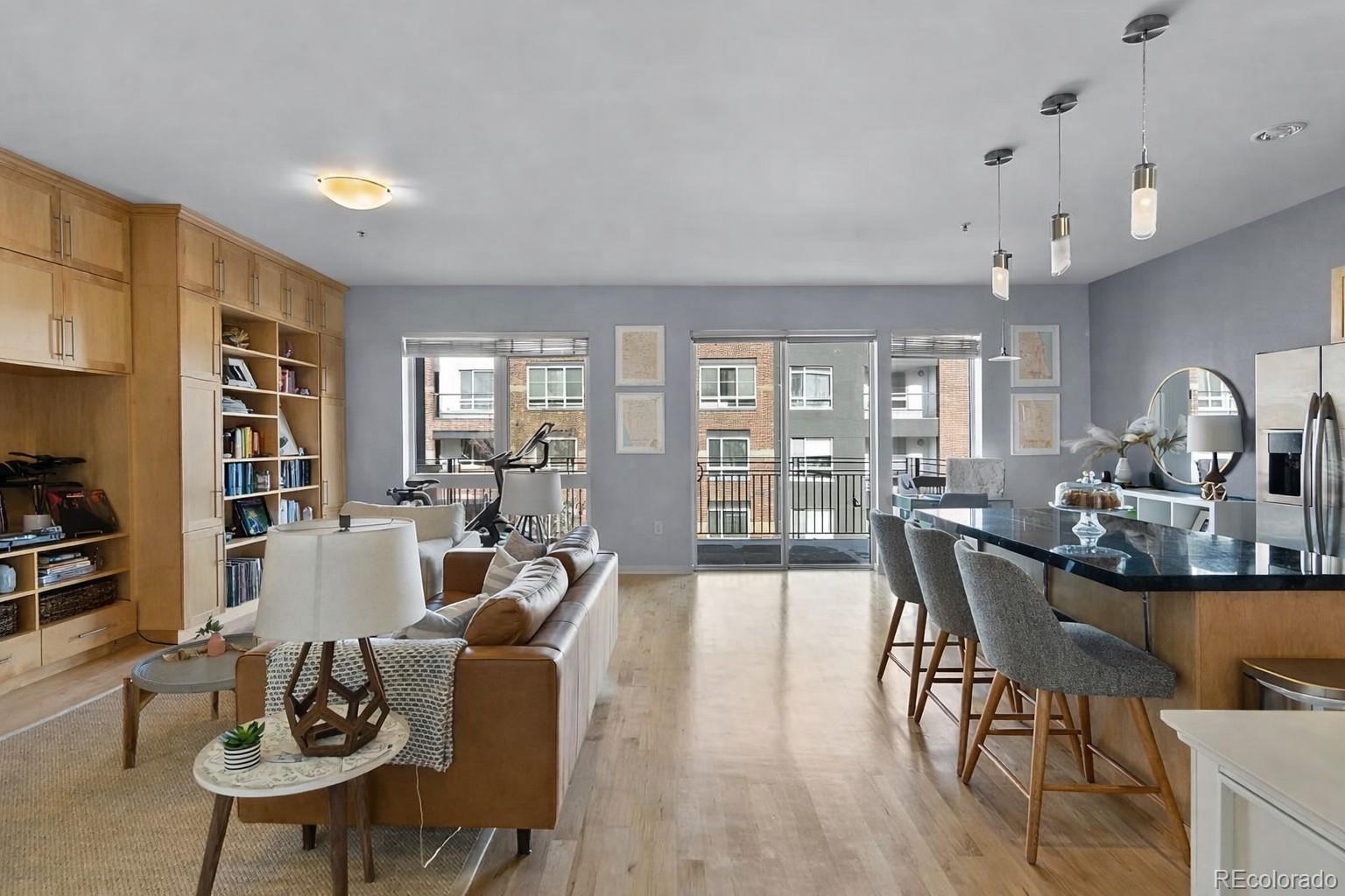 1438 Little Raven Street, Unit 310 Denver, CO 80202 - Photo 2 of 24 a living room with furniture dining table and a large window