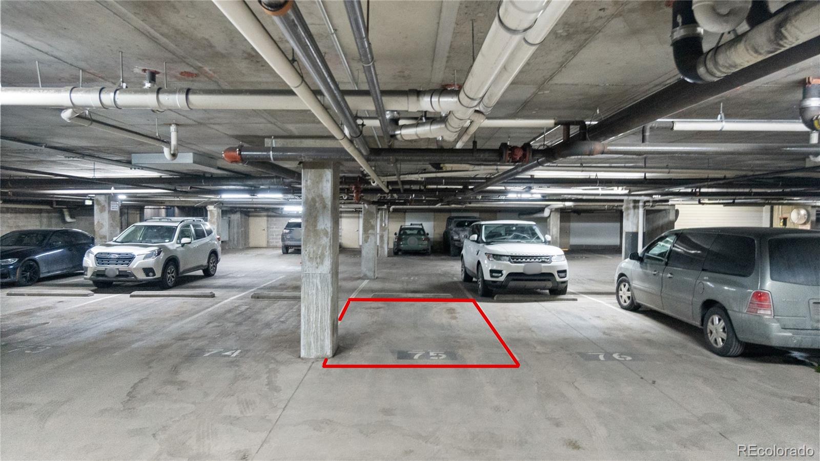 1438 Little Raven Street, Unit 310 Denver, CO 80202 - Photo 21 of 24 a view of parking garage with cars parked