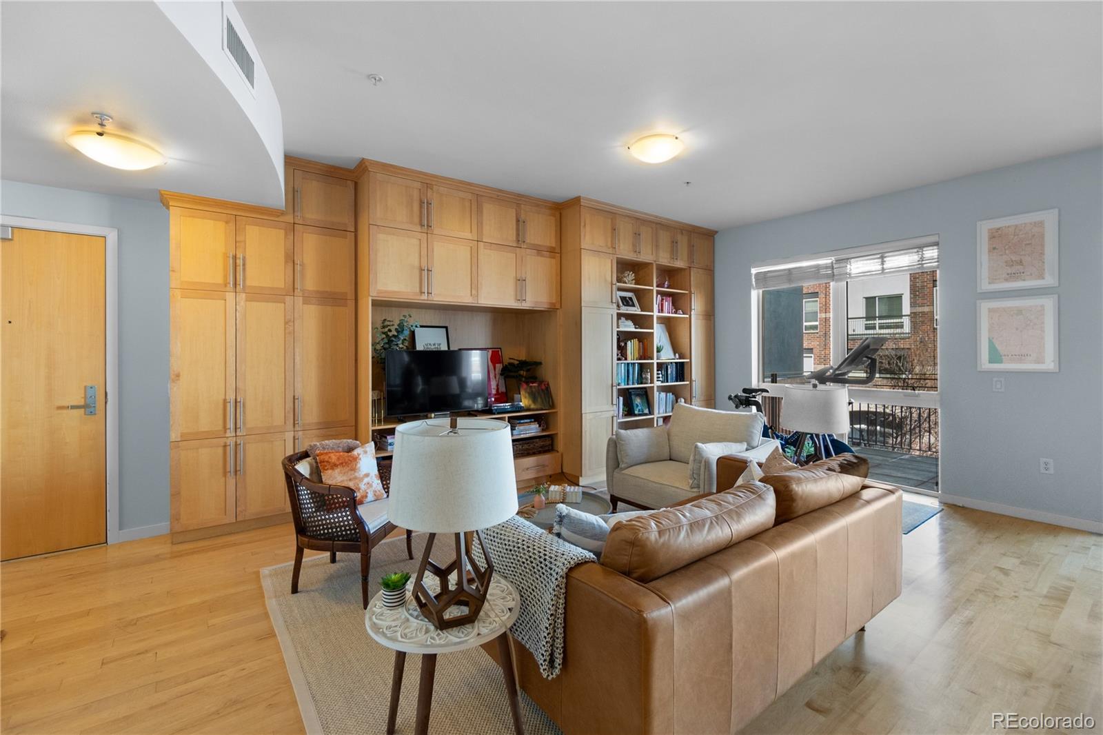 1438 Little Raven Street, Unit 310 Denver, CO 80202 - Photo 4 of 24 a living room with furniture and a flat screen tv