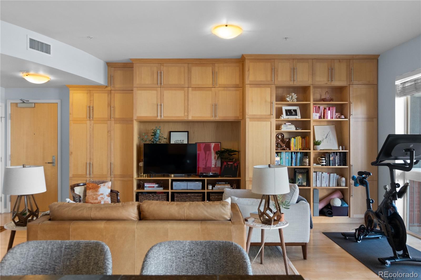 1438 Little Raven Street, Unit 310 Denver, CO 80202 - Photo 6 of 24 a living room with furniture and a flat screen tv