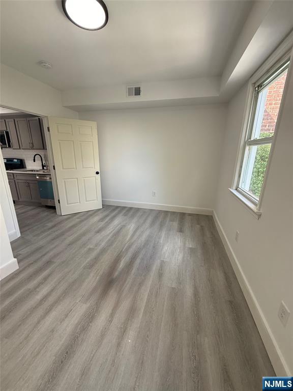 146 Maple Street, Unit 2 Kearny, NJ 07032 - Photo 7 of 12 a view of a room with wooden floor and window