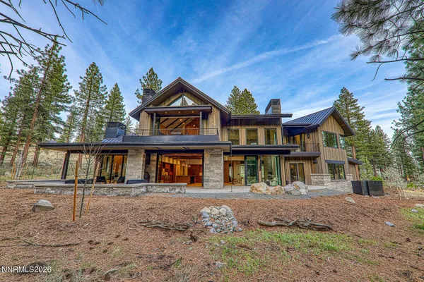 a front view of a house with a yard and trees