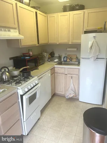 a kitchen with a stove a sink and a cabinets