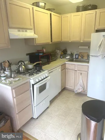 a kitchen with a stove a sink and a microwave