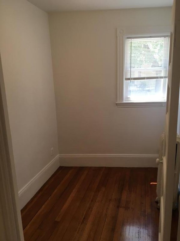 79 Brook Street, Unit 1L Brookline, MA 02445 - Photo 13 of 17 a view of a small space with wooden floor and a window