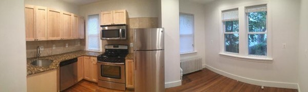 79 Brook Street, Unit 1L Brookline, MA 02445 - Photo 6 of 17 a kitchen with a refrigerator and a stove top oven