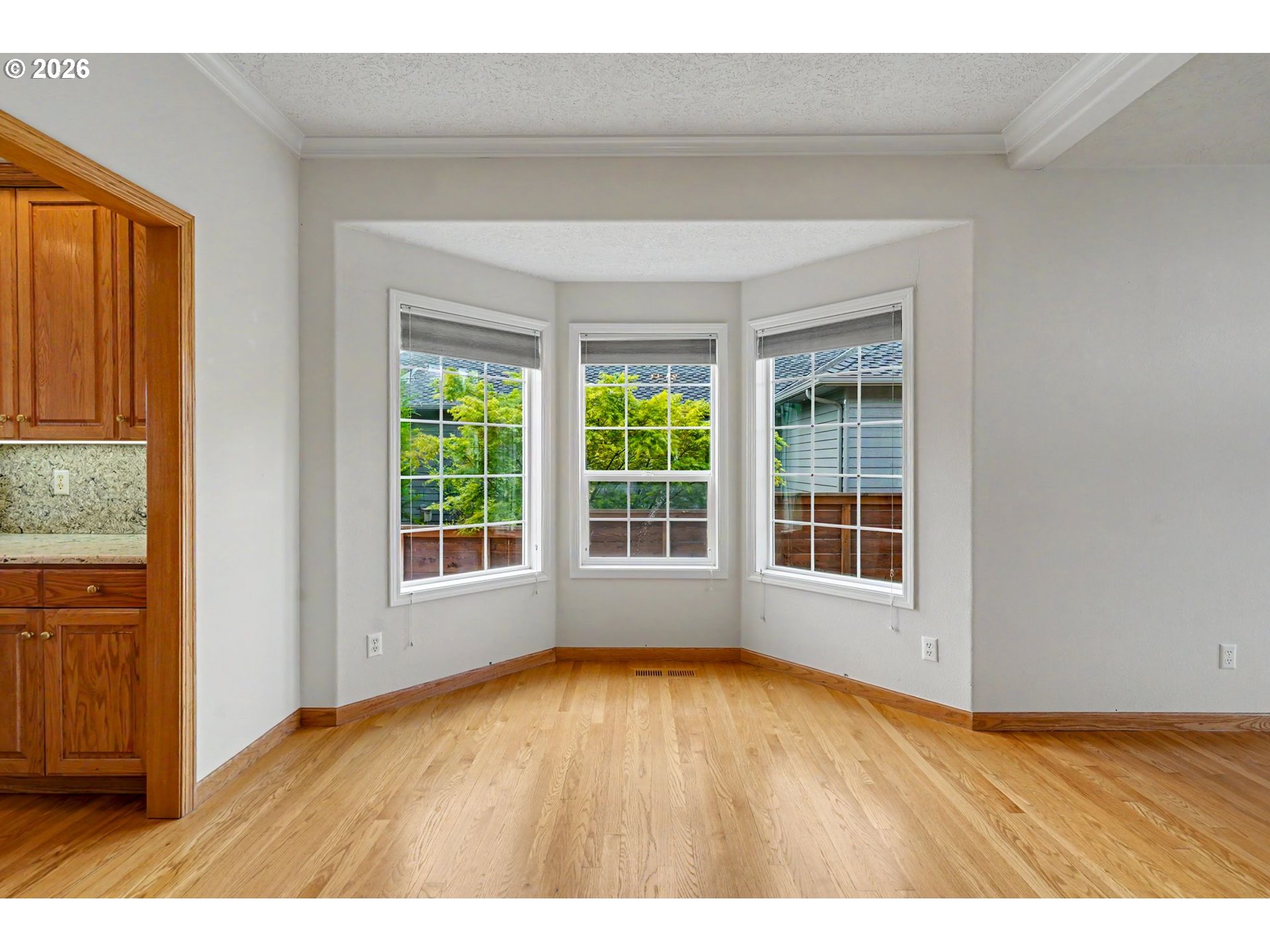 1470 Ranier Loop Northwest Salem, OR 97304 - Photo 12 of 48 a view of an empty room with wooden floor and a window
