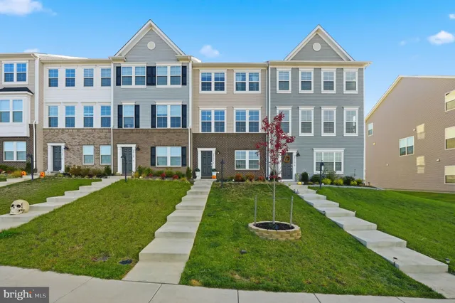 a front view of building with yard and green space
