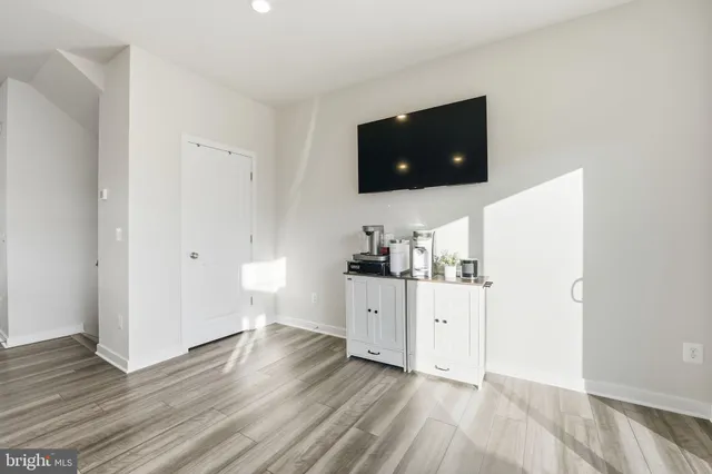 a kitchen with cabinets and wooden floor