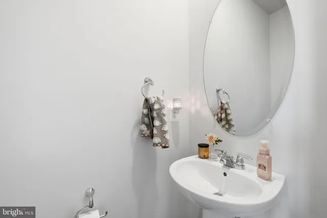 a bathroom with a sink and mirror