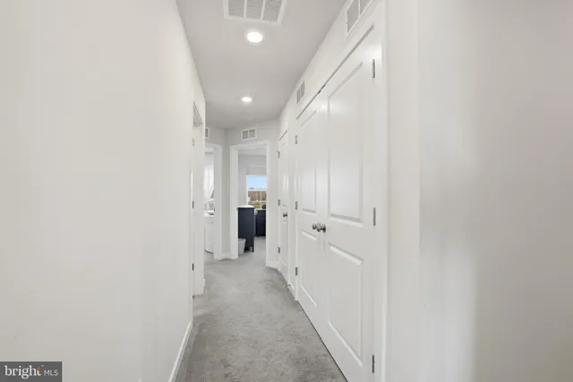 a view of a hallway with a white walls