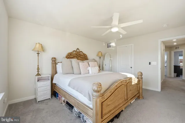 a large bed sitting in a bedroom and chandelier