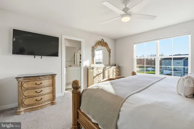 a large bedroom with a bed and a flat screen tv