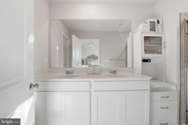 a bathroom with double sink and a mirror