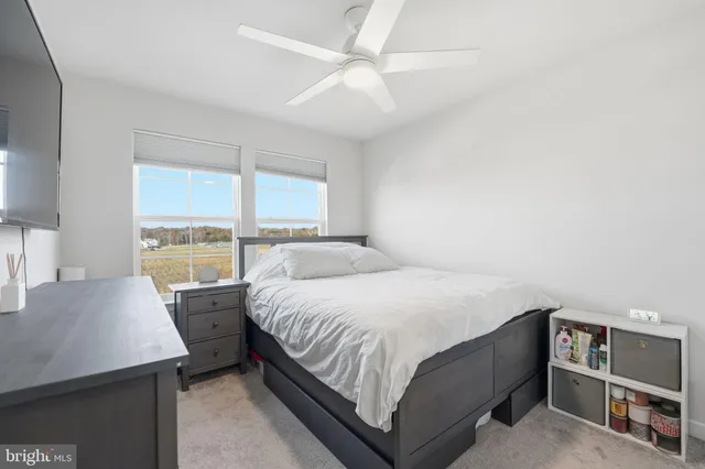 a bedroom with a bed and a large window