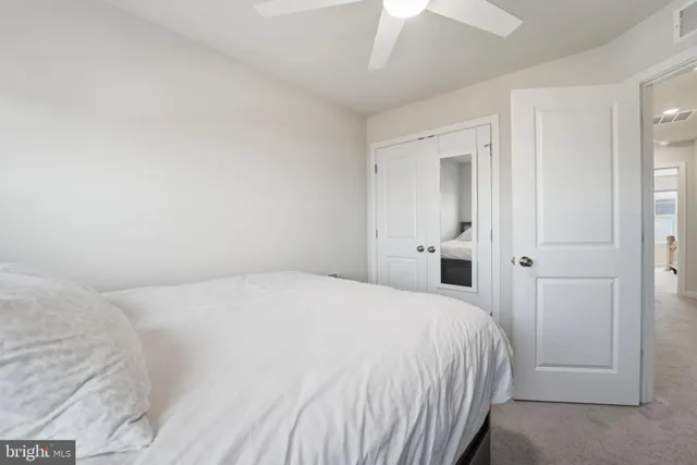 a large bed in a white room