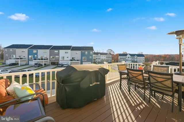 a view of a balcony with two chairs and a potted plant
