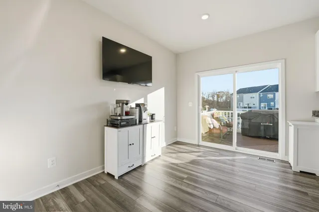a view of a livingroom with wooden floor and furniture