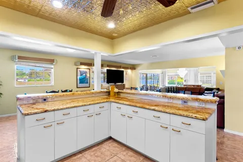 a living room with patio furniture and a large window