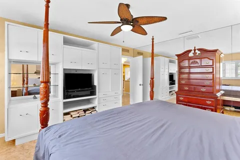 a bedroom with a bed and a large window