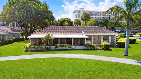 an aerial view of a house with a garden and swimming pool