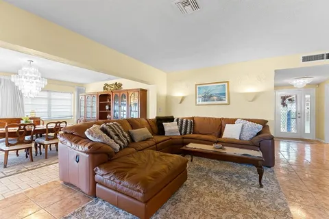 a kitchen with stainless steel appliances granite countertop table chairs and a refrigerator