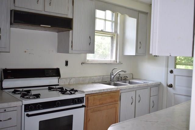 1323 Old Freeport Road Pittsburgh, PA 15238 - Photo 7 of 14 Galley kitchen, with door to backyard, shared wall with dining room